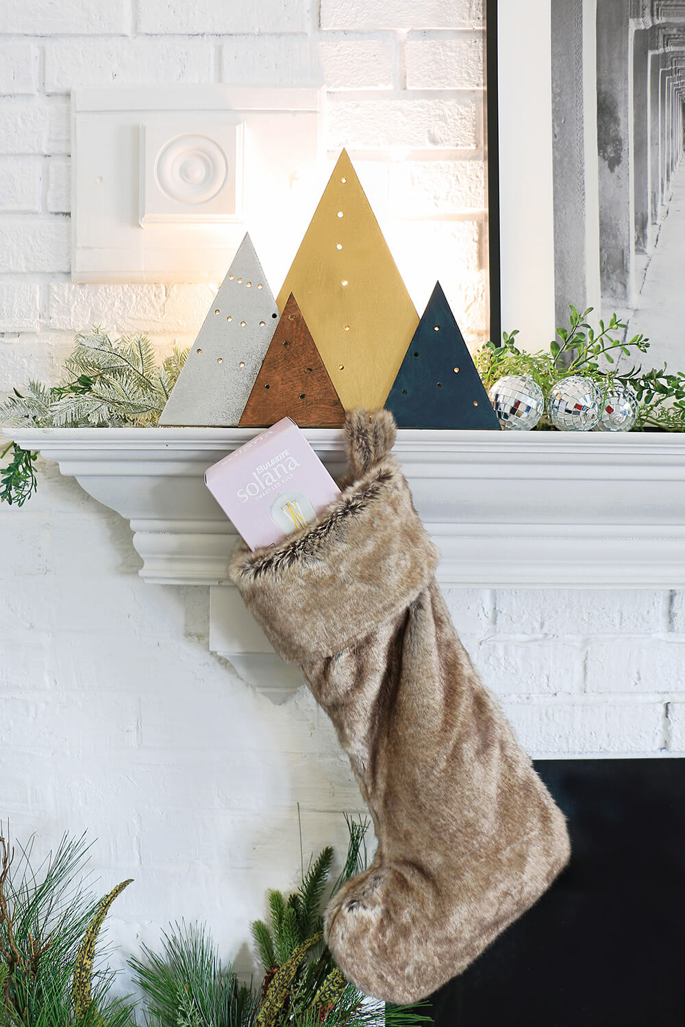 Holiday light with stocking on mantel